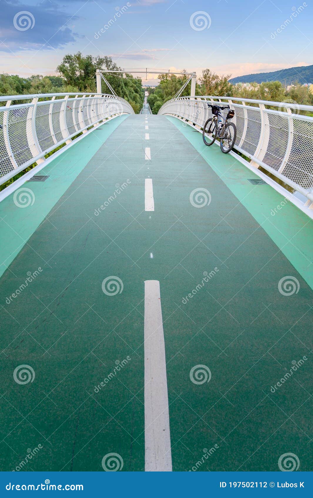empty bicycle bridge called Ã¢â¬Åfreedom bridgeÃ¢â¬Â connecting two countries slovakia and austria during sunset bratislava,